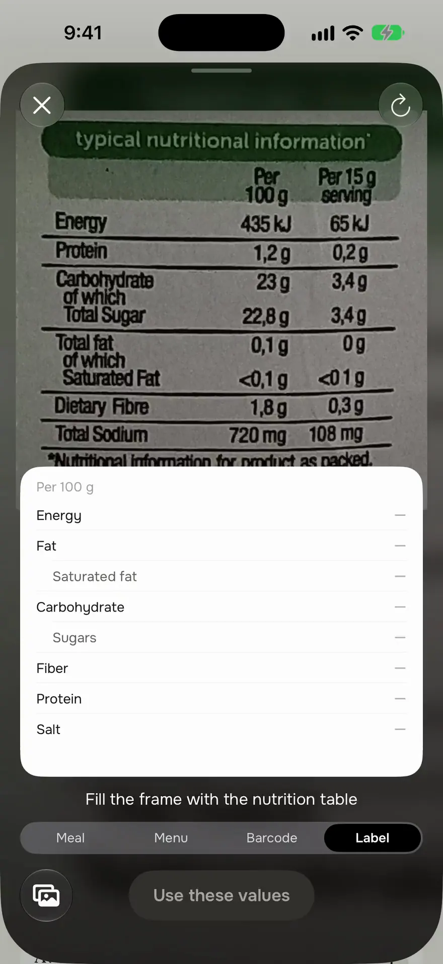 The label scanner reading a ketchup label: per 100 g, 104 kcal, 0.1 g fat, 23 g carbohydrate with 22.8 g sugars, 1.8 g fibre, 1.2 g protein and 720 mg sodium, with a button to use these values